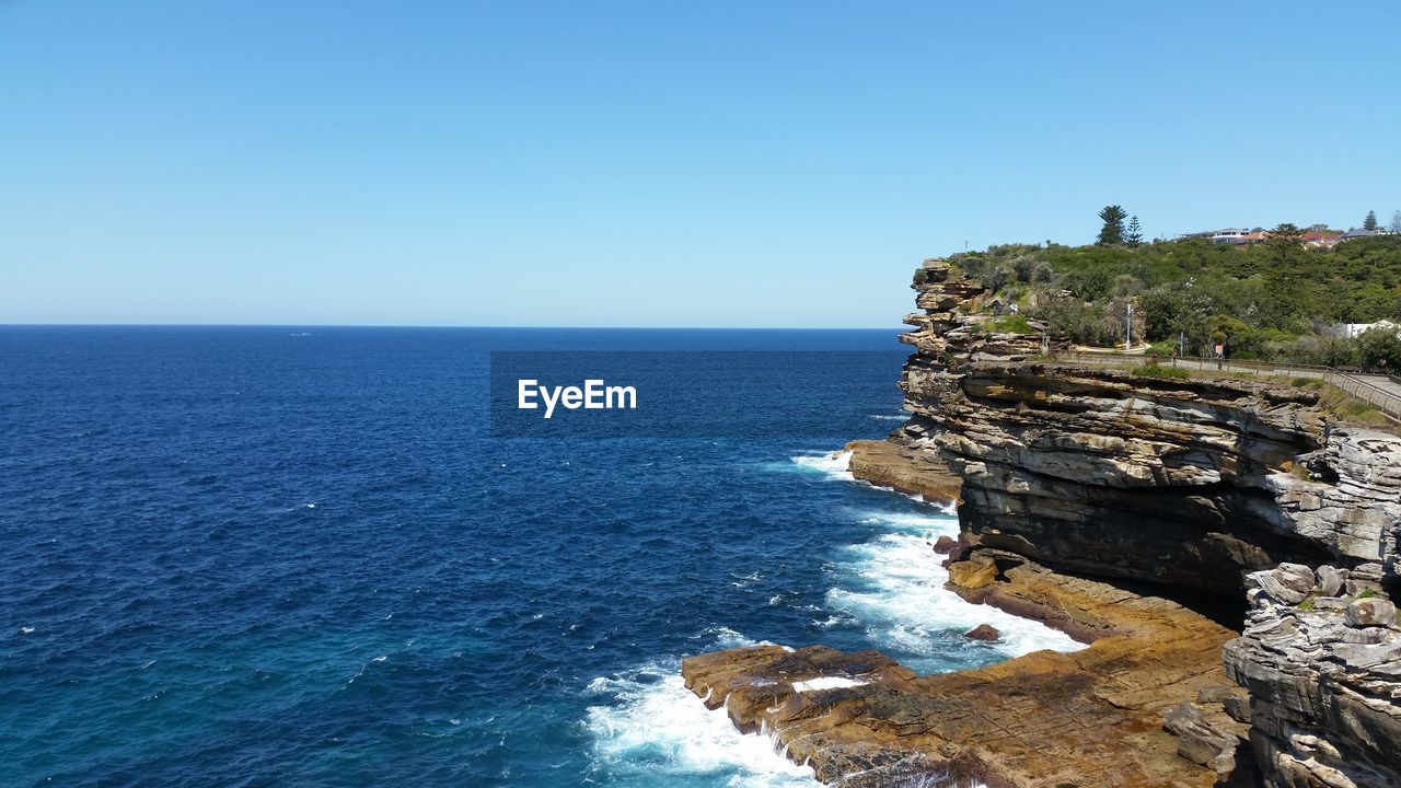 SCENIC VIEW OF SEA WITH ROCKS IN BACKGROUND