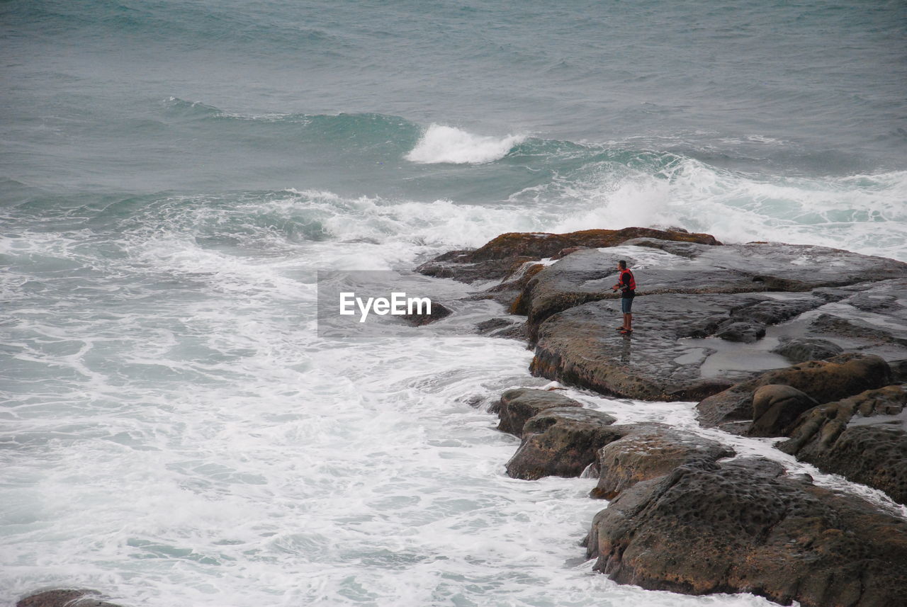 High angle view of man fishing in sea