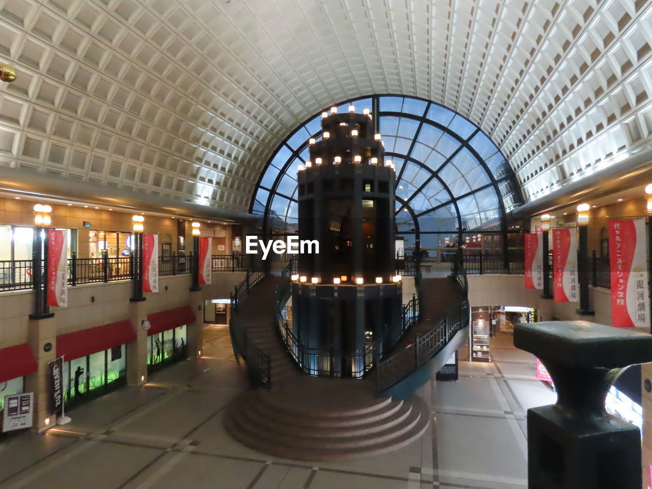 REAR VIEW OF MAN ON ILLUMINATED ESCALATOR