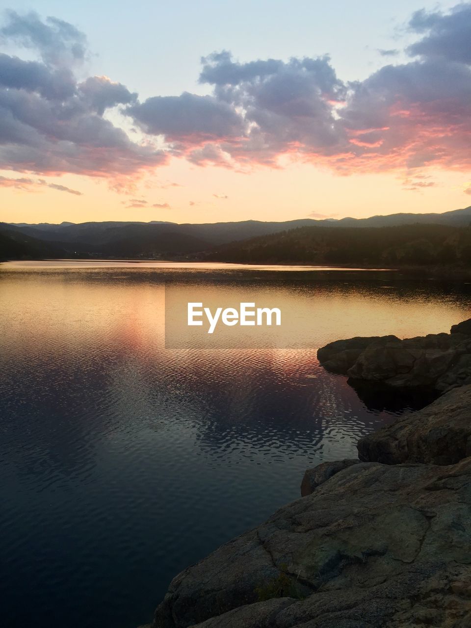 Scenic view of lake against sky during sunset