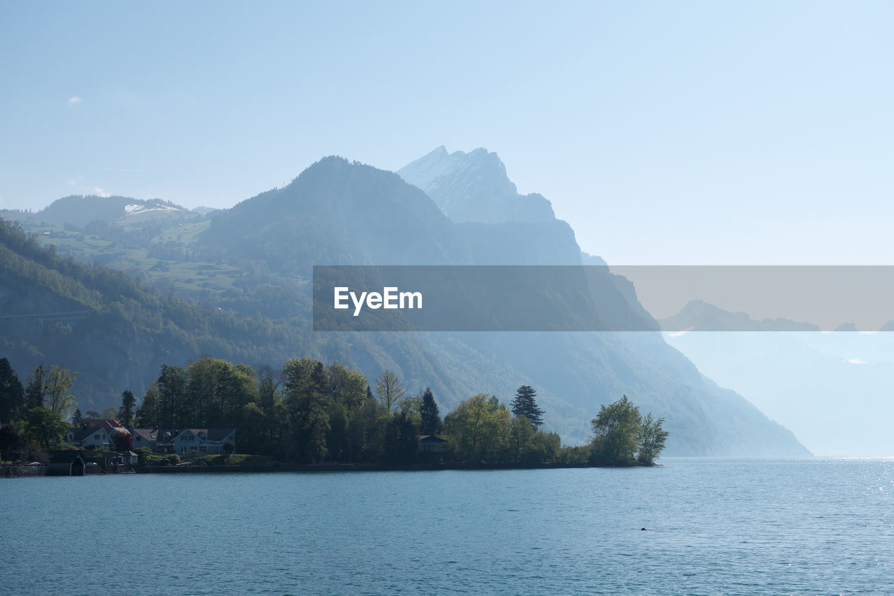 Scenic view of lake and mountains against sky