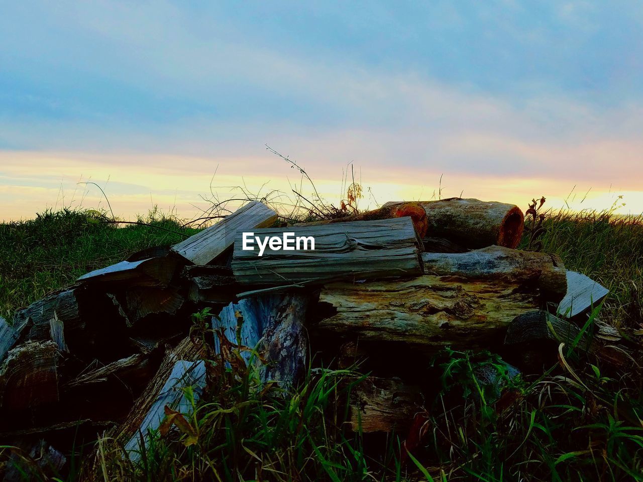 ABANDONED WOOD AGAINST SKY AT SUNSET