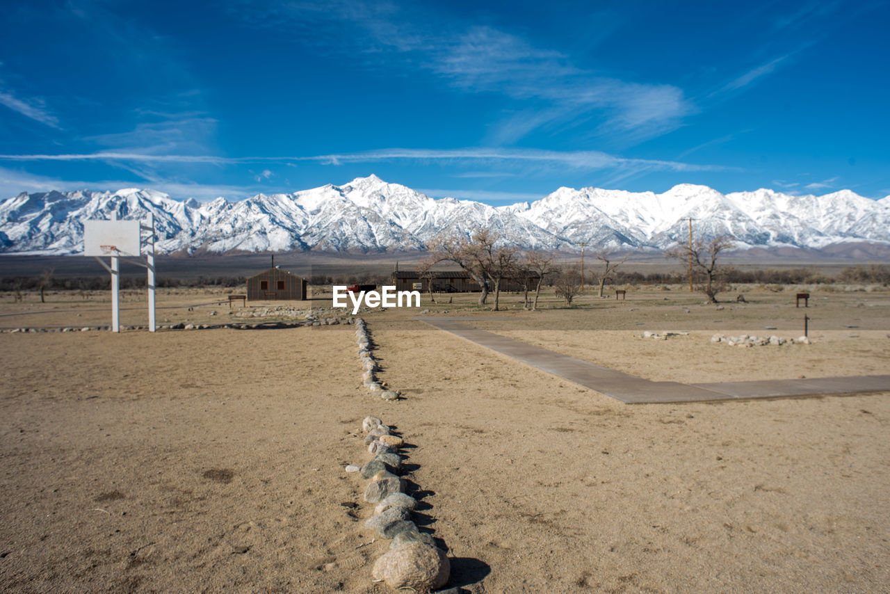 Scenic view of snowcapped mountains against blue sky