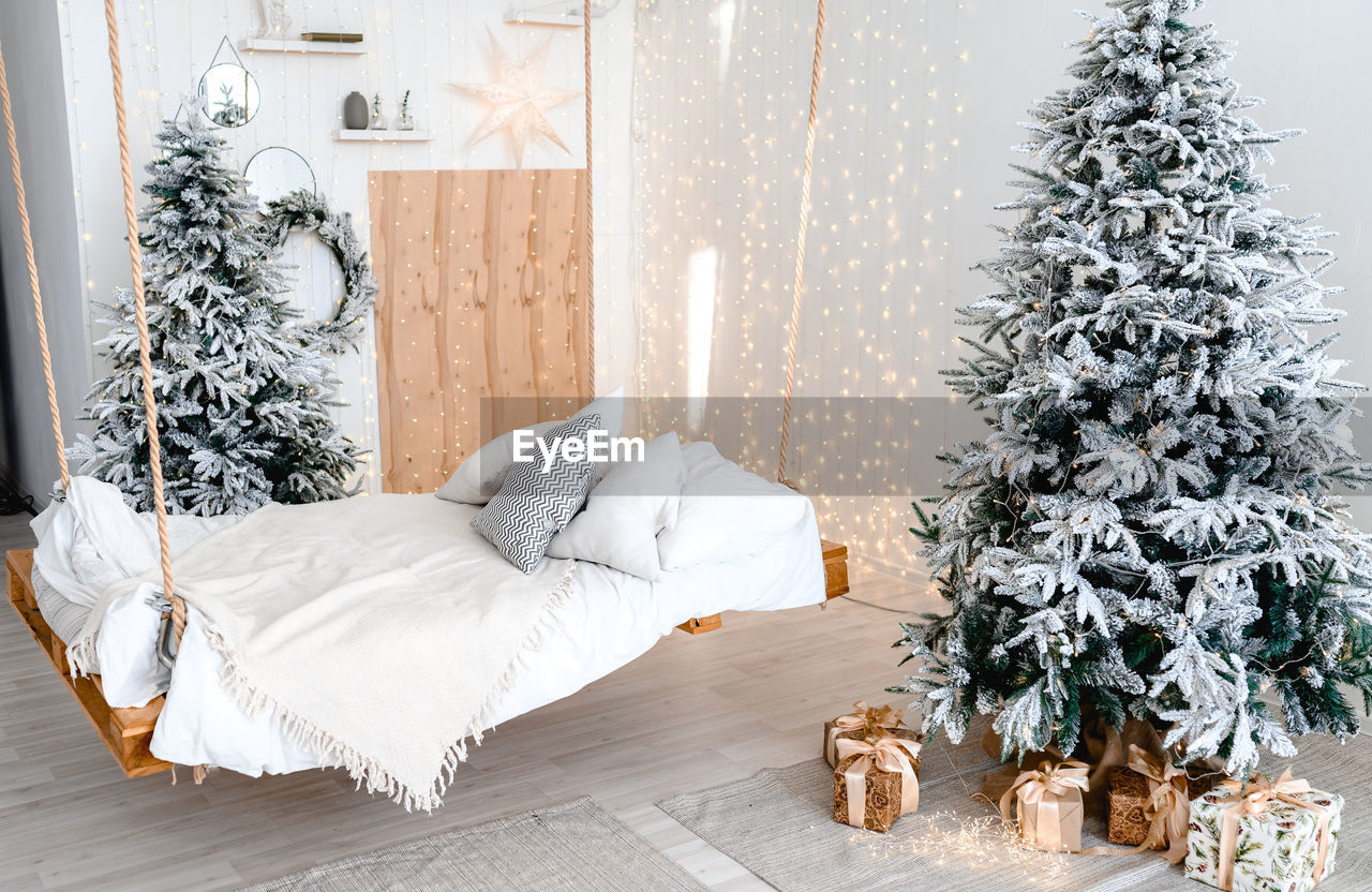 White bedroom apartments decorating christmas tree and shine light