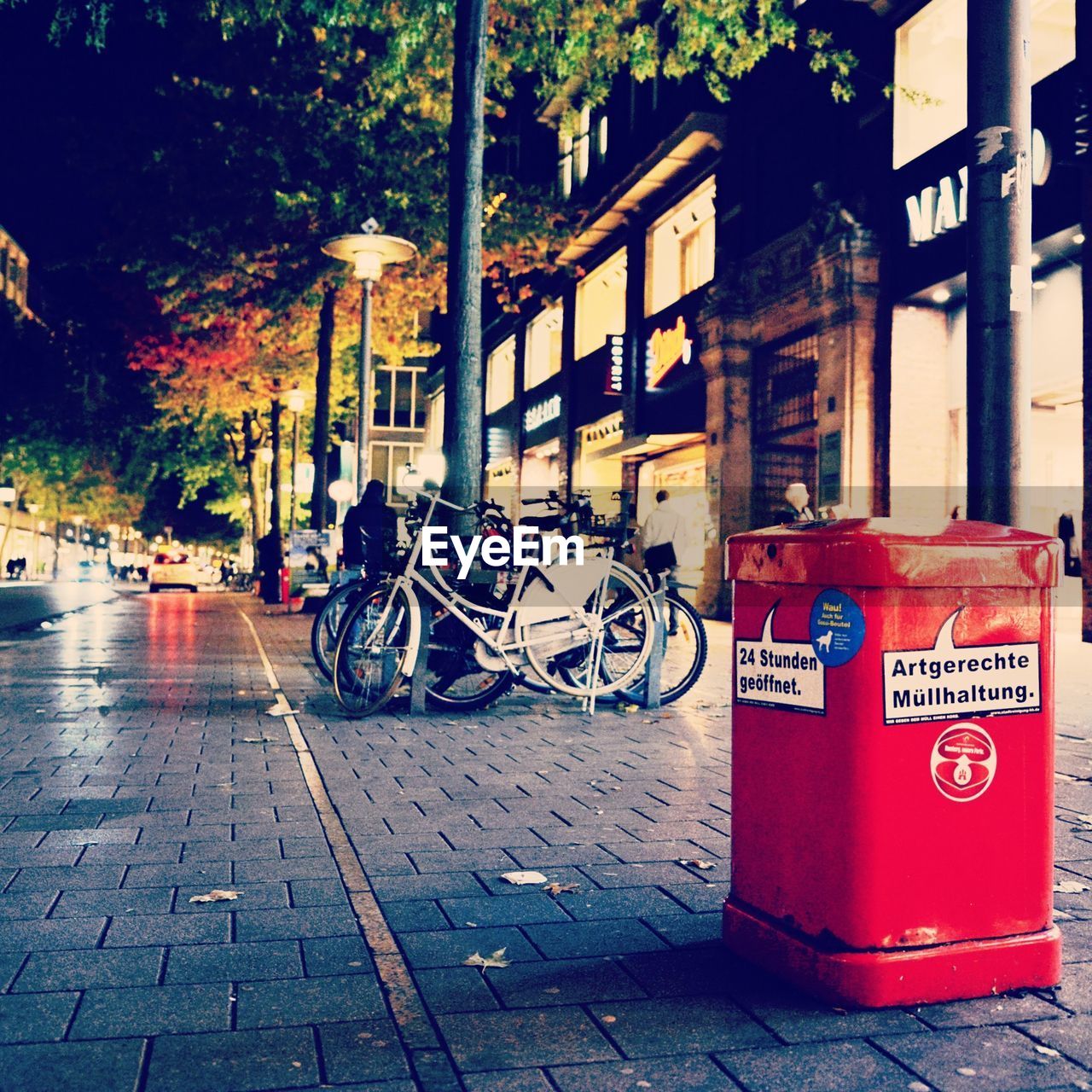 BICYCLES ON FOOTPATH BY STREET AGAINST BUILDING