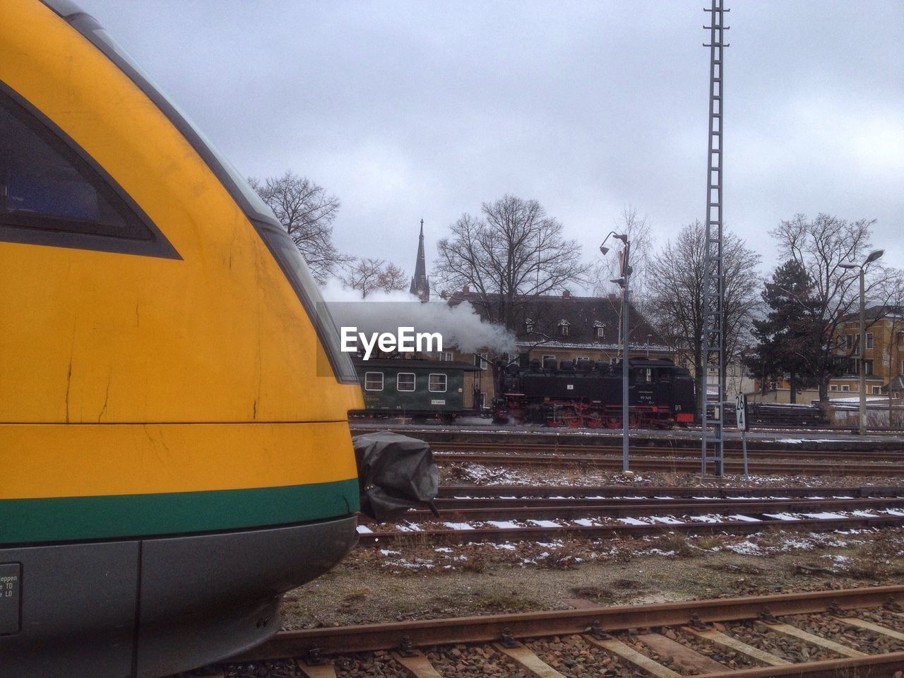 Cropped image of train on railway tracks against sky