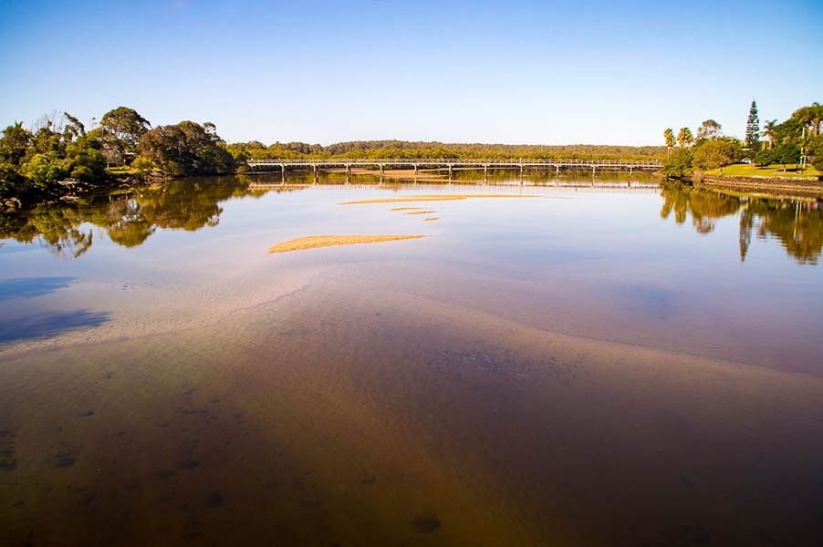 SCENIC VIEW OF CALM LAKE AGAINST CLEAR SKY