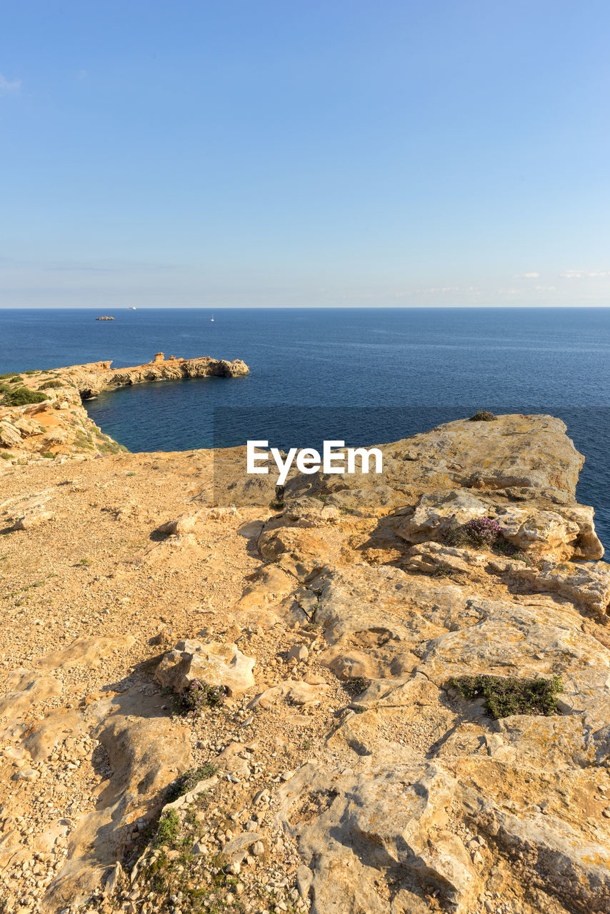 Scenic view of sea against clear blue sky