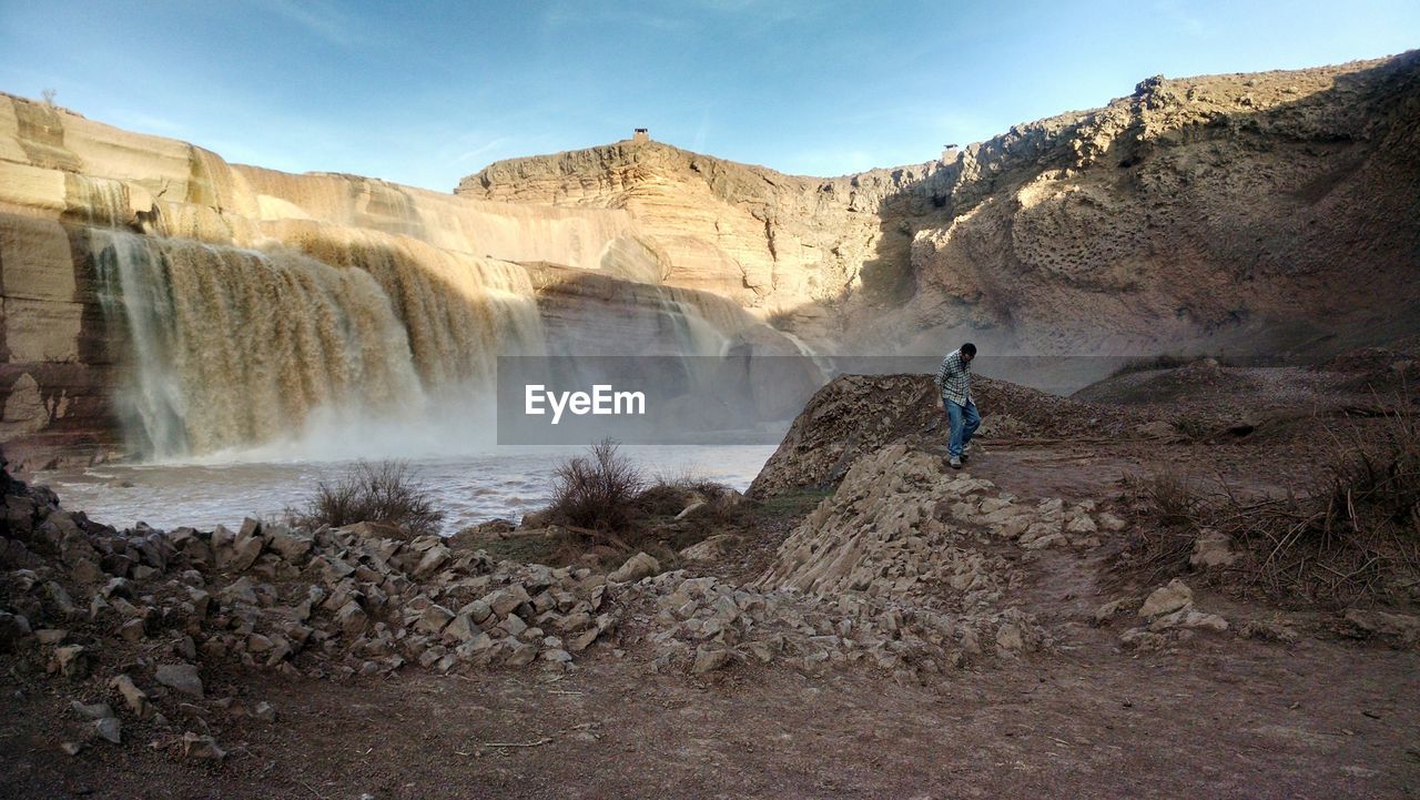 SCENIC VIEW OF WATERFALL AGAINST LANDSCAPE