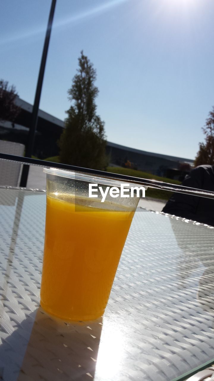 Close-up of beer in glass against clear sky