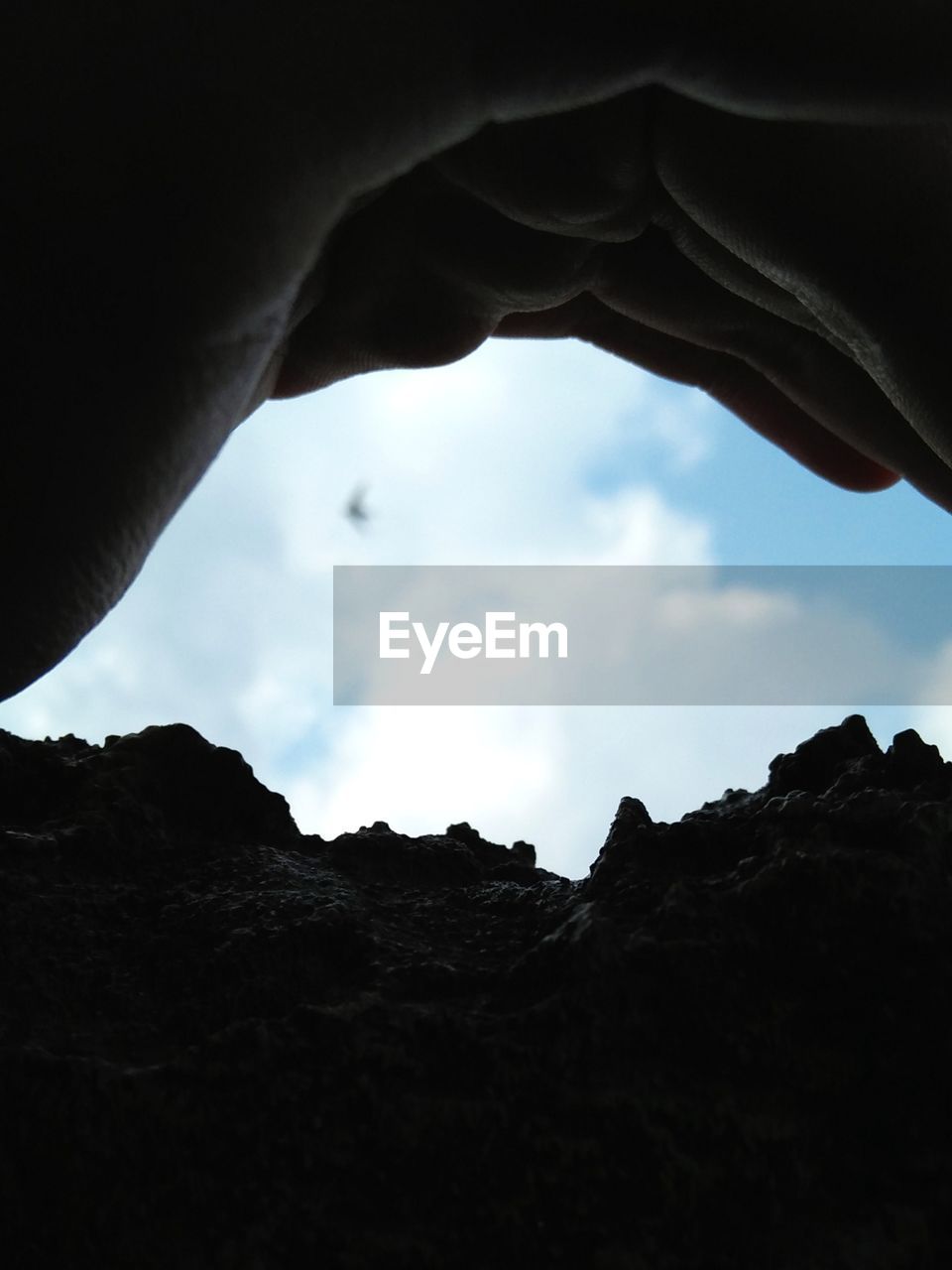 LOW ANGLE VIEW OF SILHOUETTE ROCK FORMATION AGAINST SKY