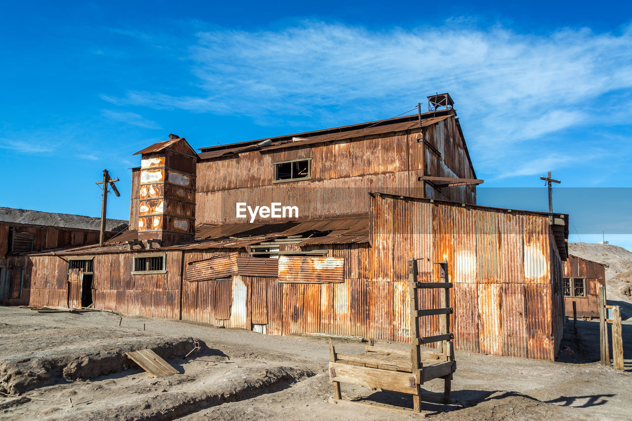 Exterior of abandoned built structure against sky