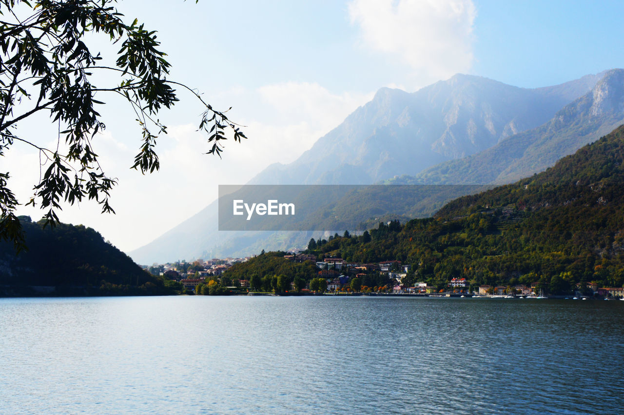 Scenic view of lake by mountains against sky