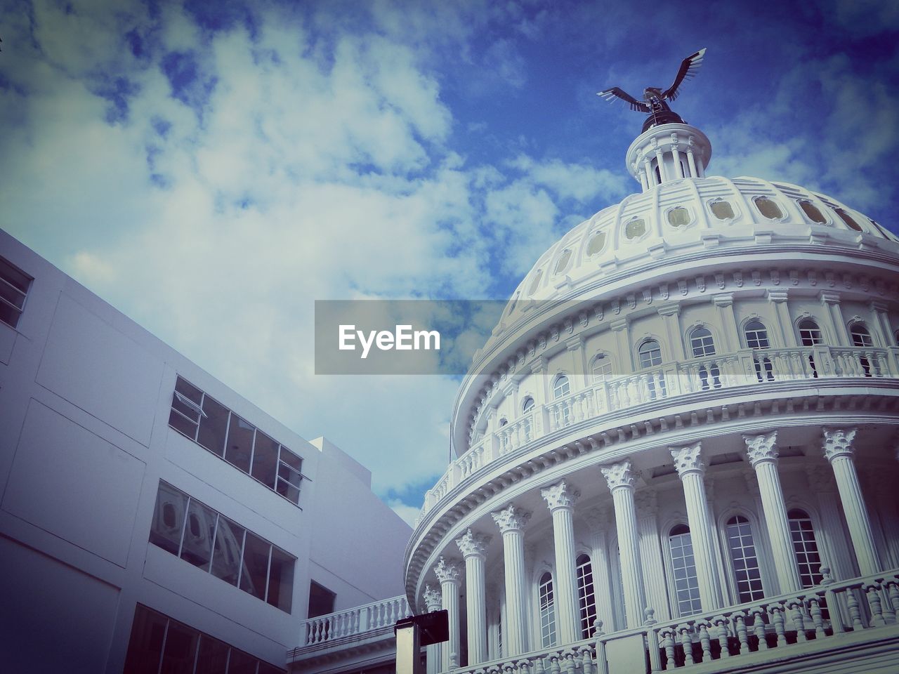 Low angle view of building against cloudy sky