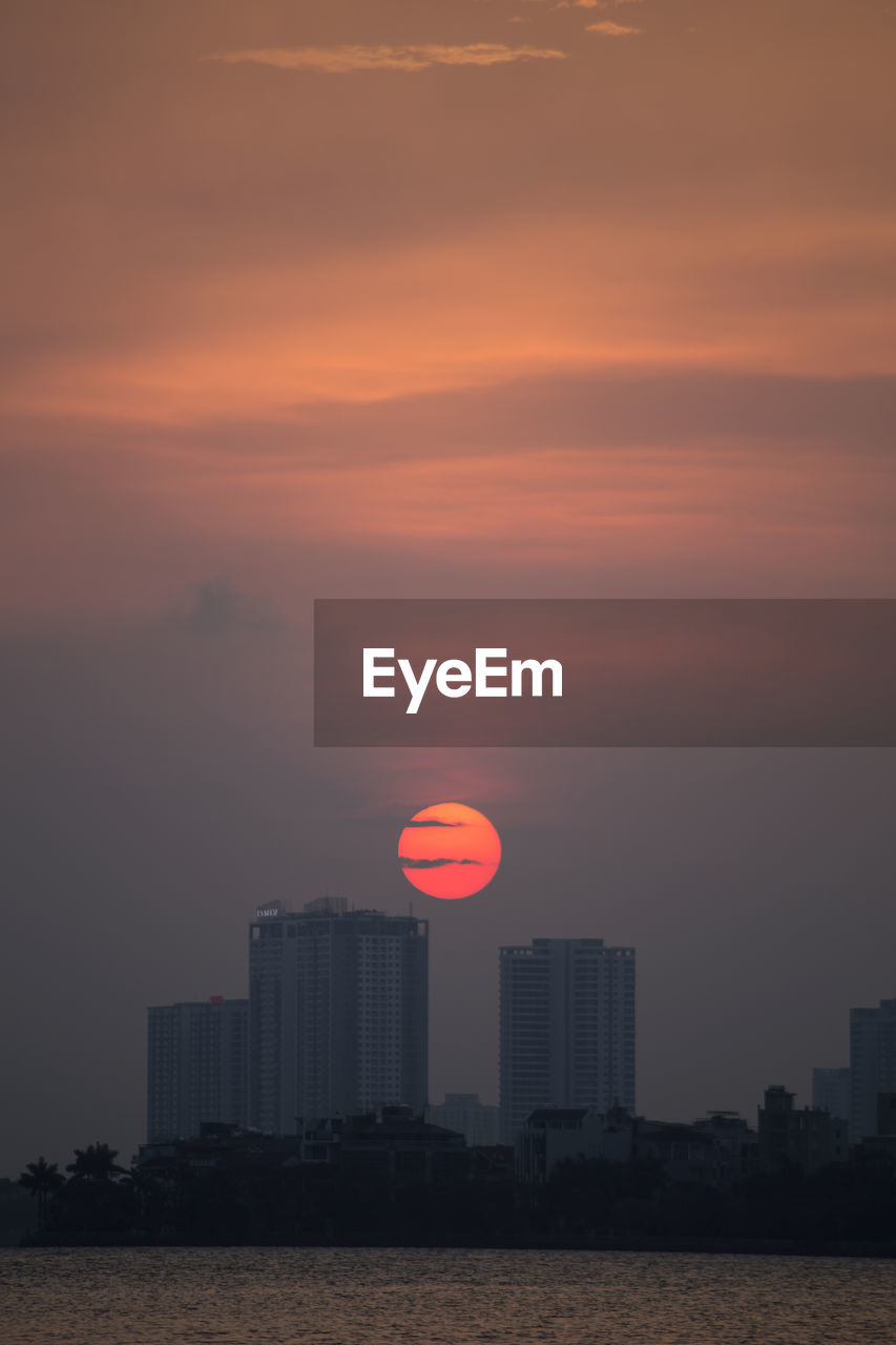 Buildings against sky during sunset