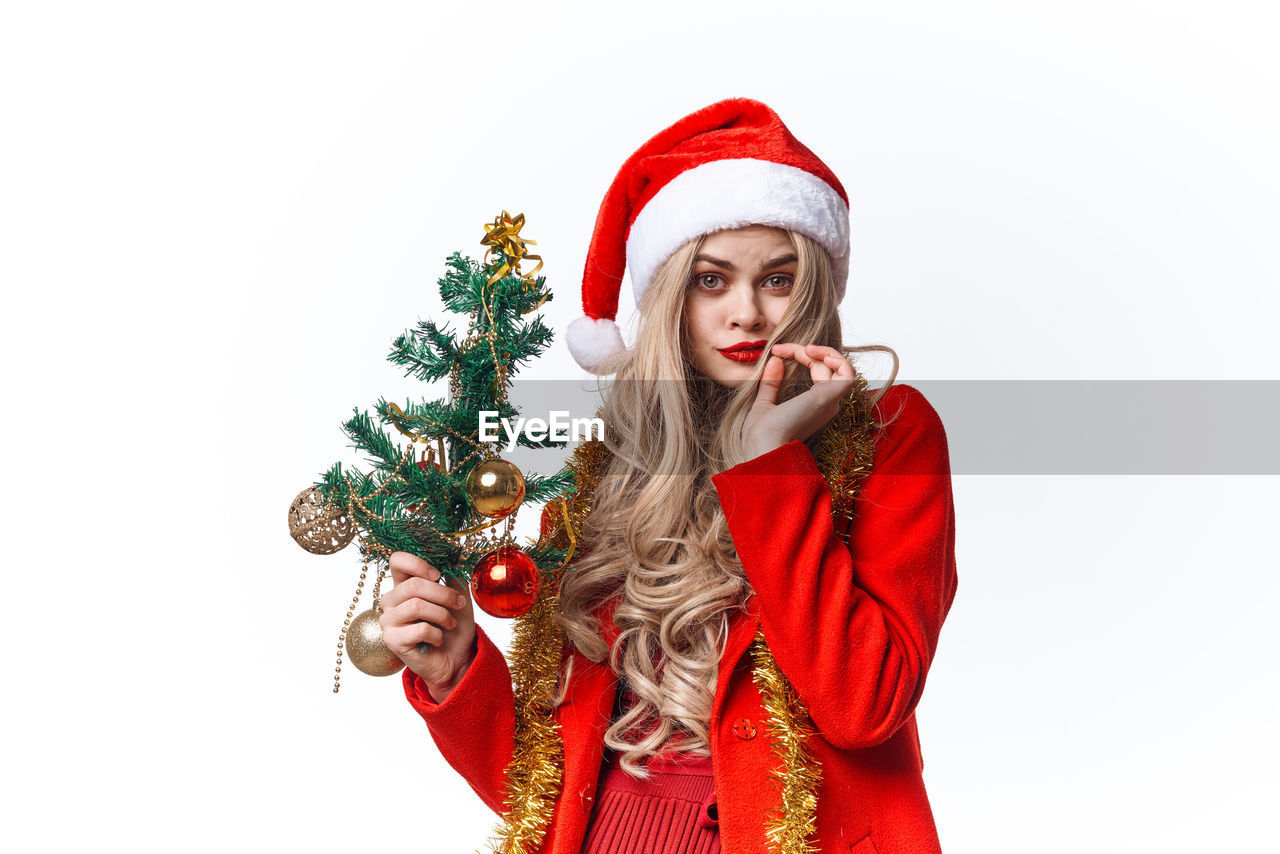 YOUNG WOMAN WITH UMBRELLA IN CHRISTMAS TREE