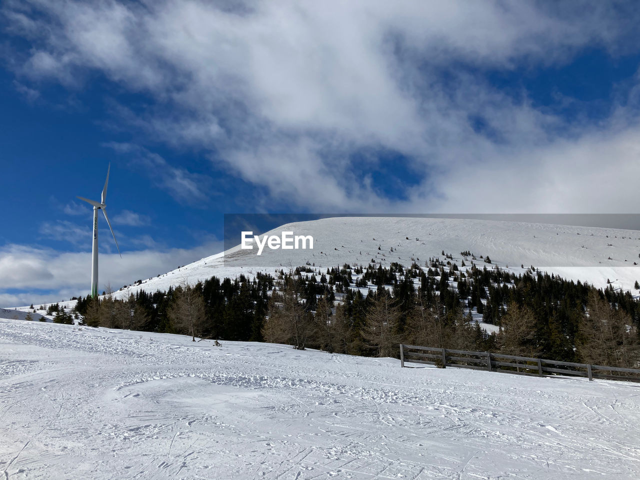 Snow covered field against sky