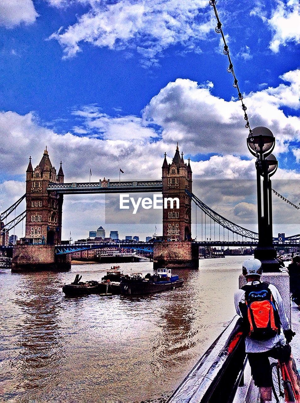 BRIDGE OVER RIVER WITH CITY IN BACKGROUND