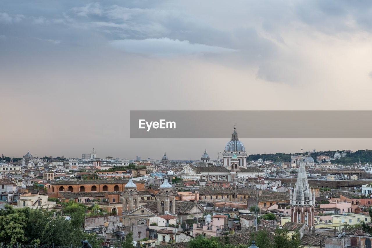 Cityscape against cloudy sky