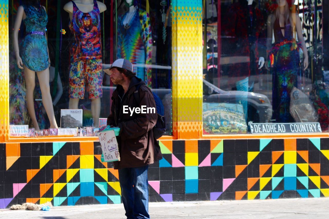 WOMAN STANDING ON CITY STREET