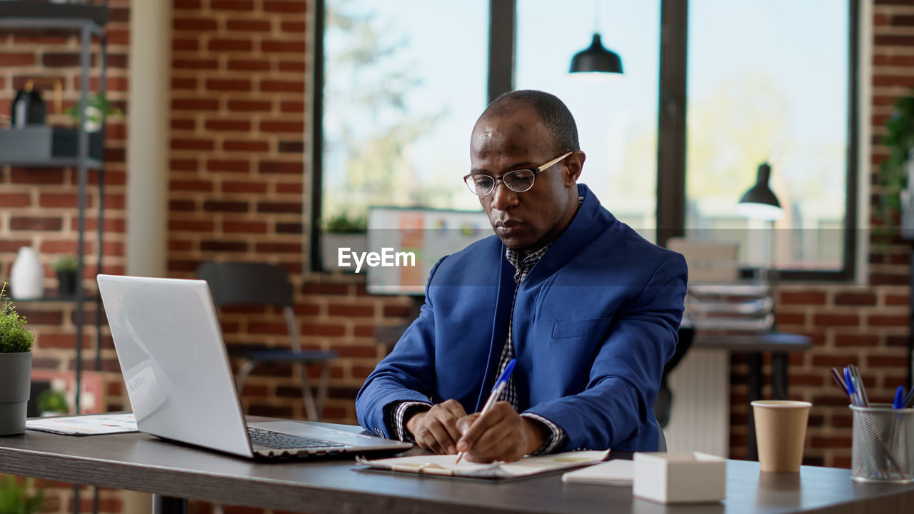 Young man using laptop at office