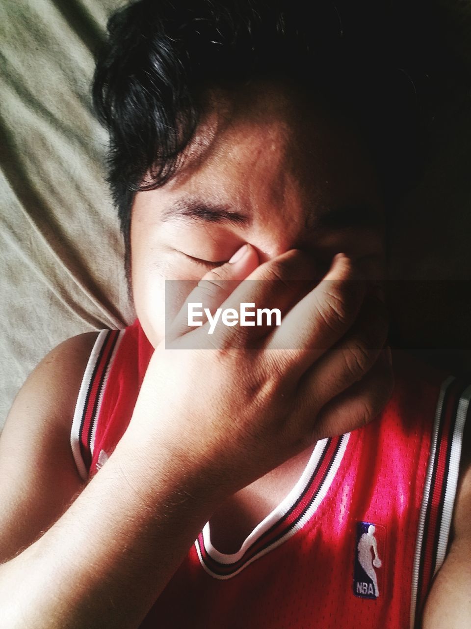 CLOSE-UP OF BOY WITH EYEGLASSES ON HAND