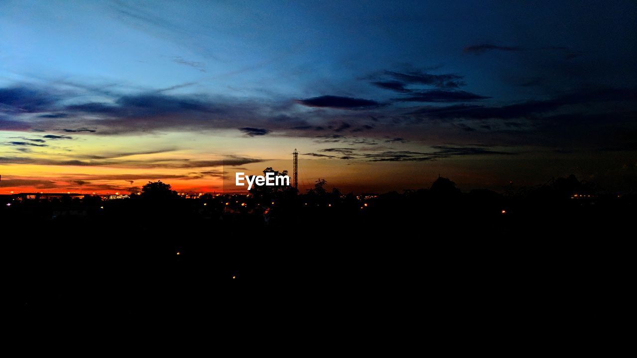 SCENIC VIEW OF SILHOUETTE LANDSCAPE AGAINST DRAMATIC SKY