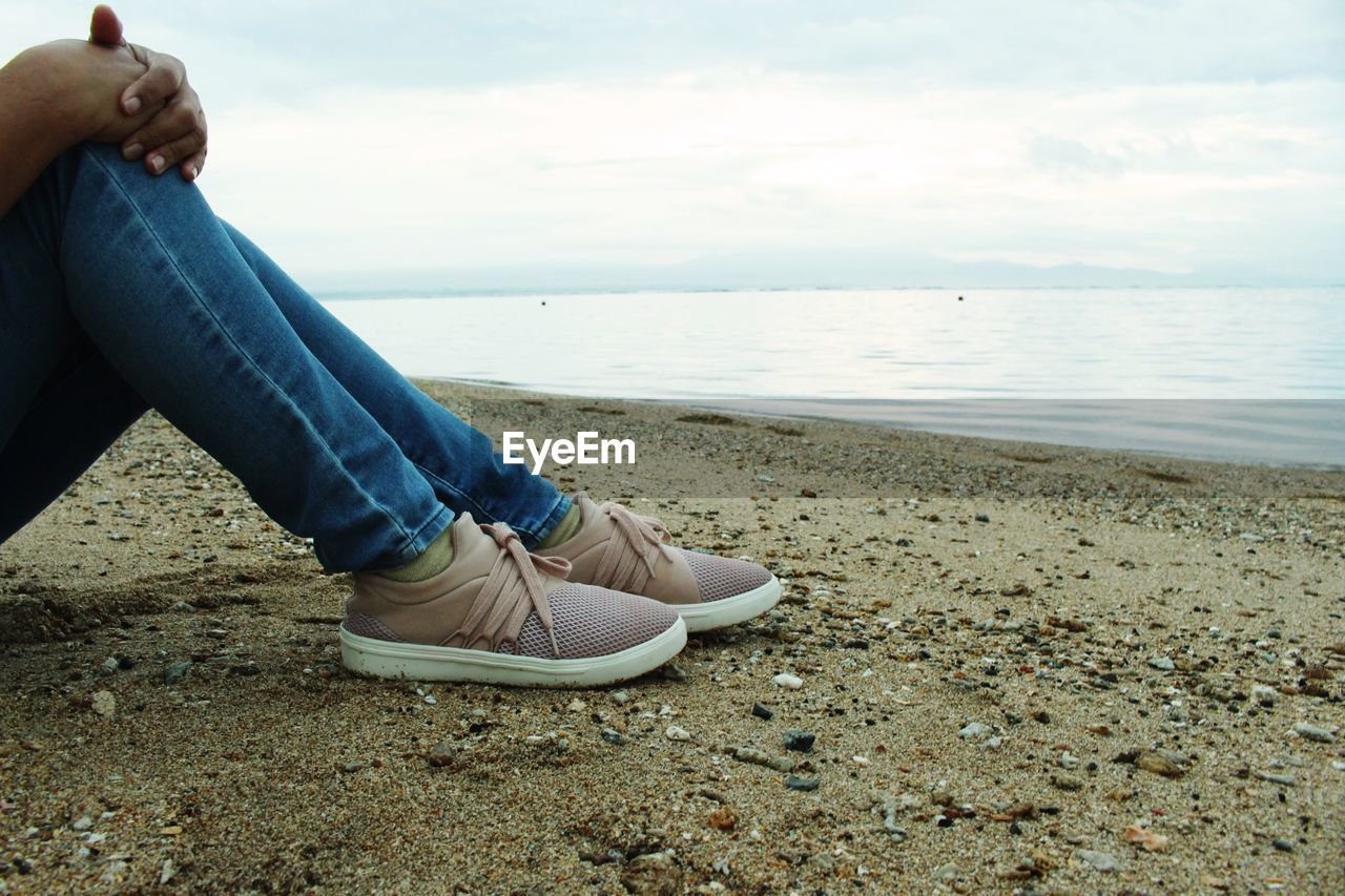 LOW SECTION OF PERSON ON BEACH