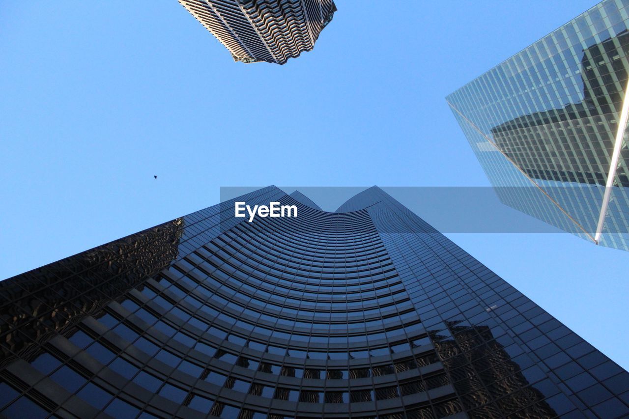 LOW ANGLE VIEW OF BUILDINGS AGAINST BLUE SKY