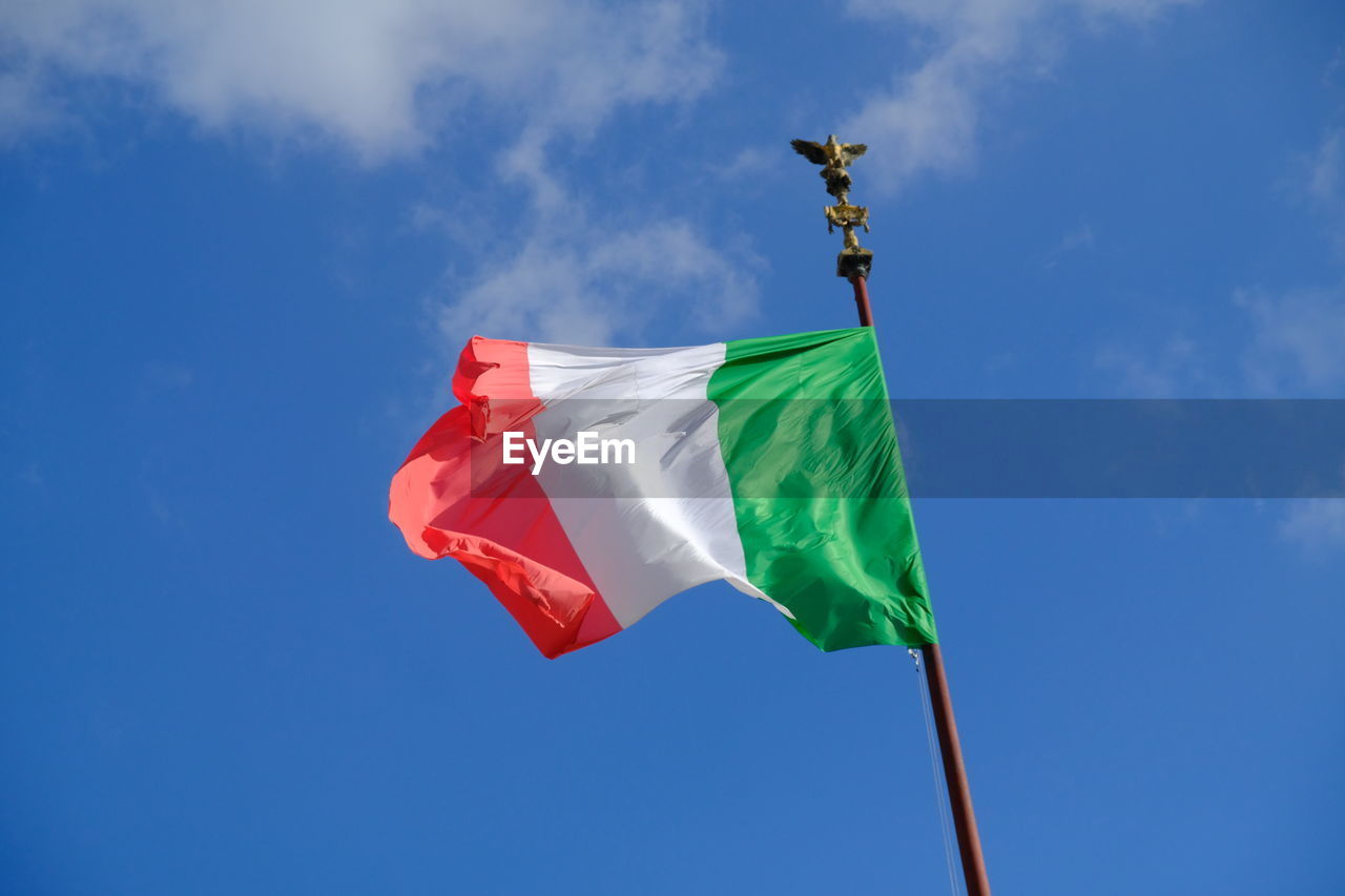 Low angle view of italian flag against blue sky