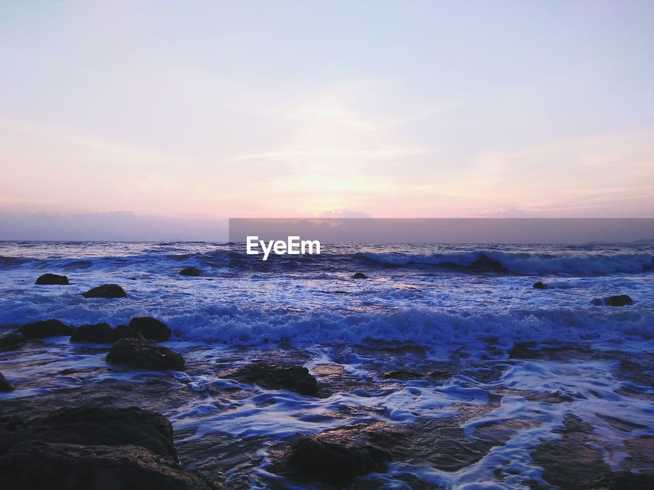 SCENIC VIEW OF BEACH AGAINST SKY DURING SUNSET