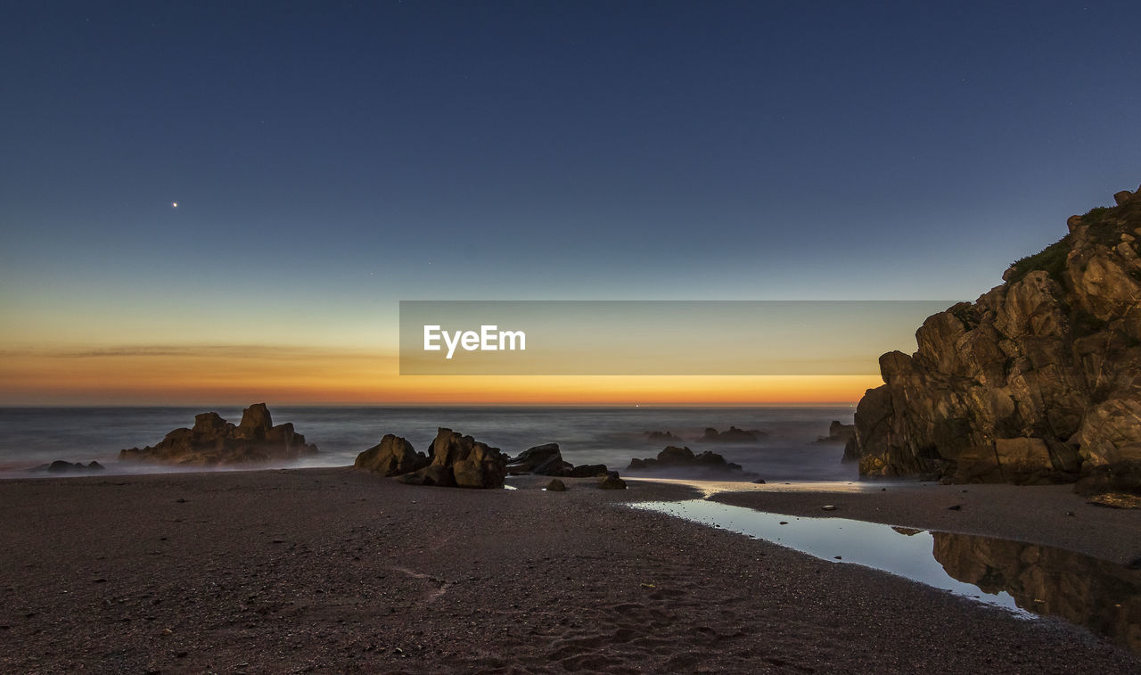 Scenic view of sea against sky during sunset