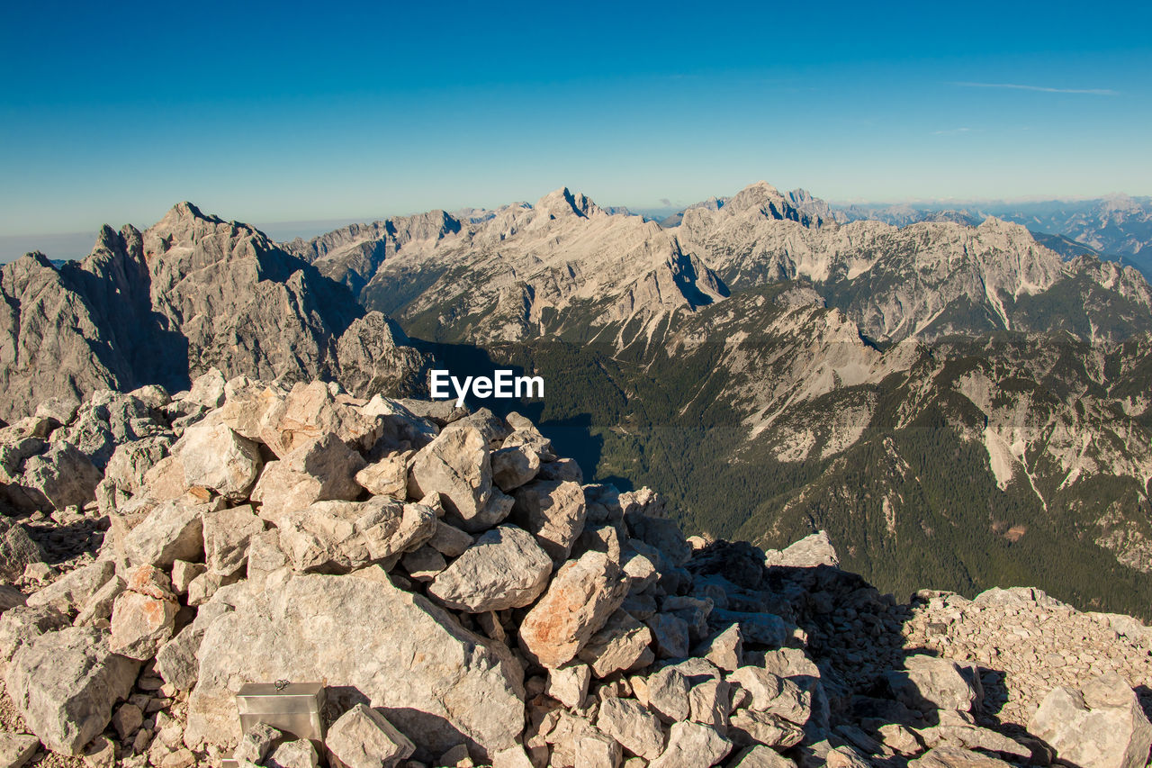 Rocks on mountain against blue sky