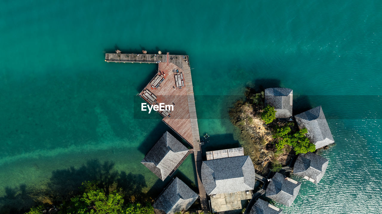 high angle view of townscape by sea against sky