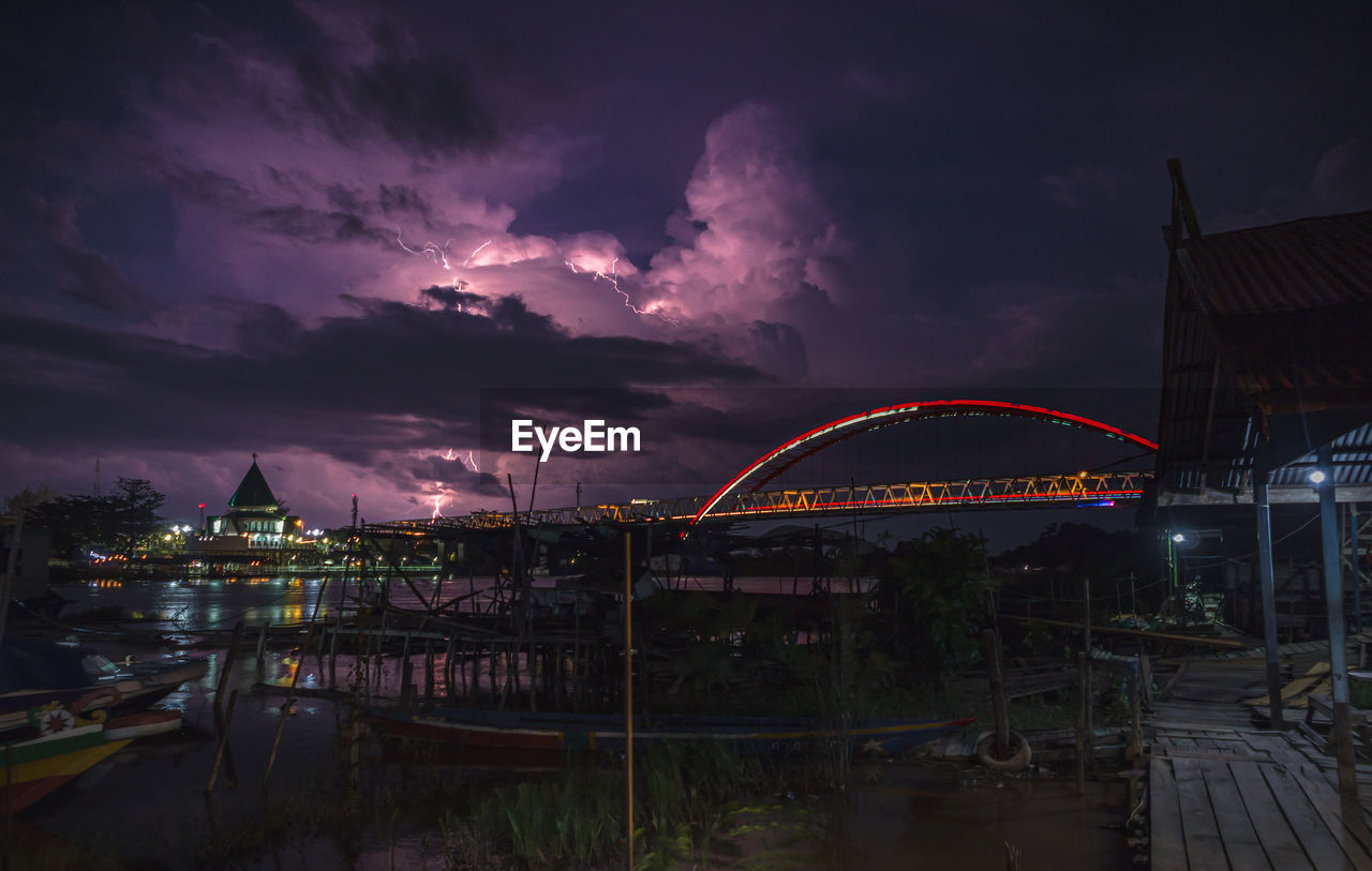 Lightning beside bridge and mosque