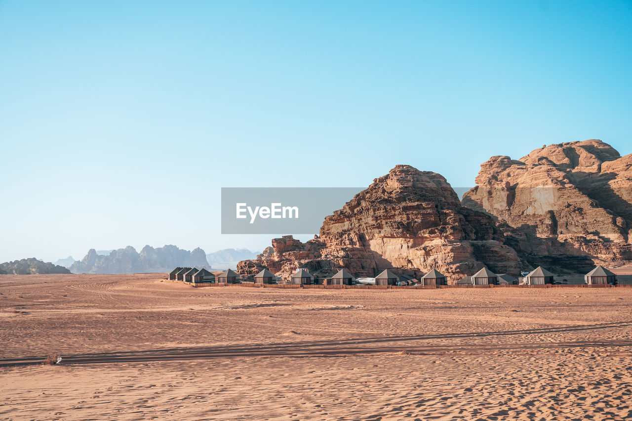 Scenic view of desert against clear blue sky