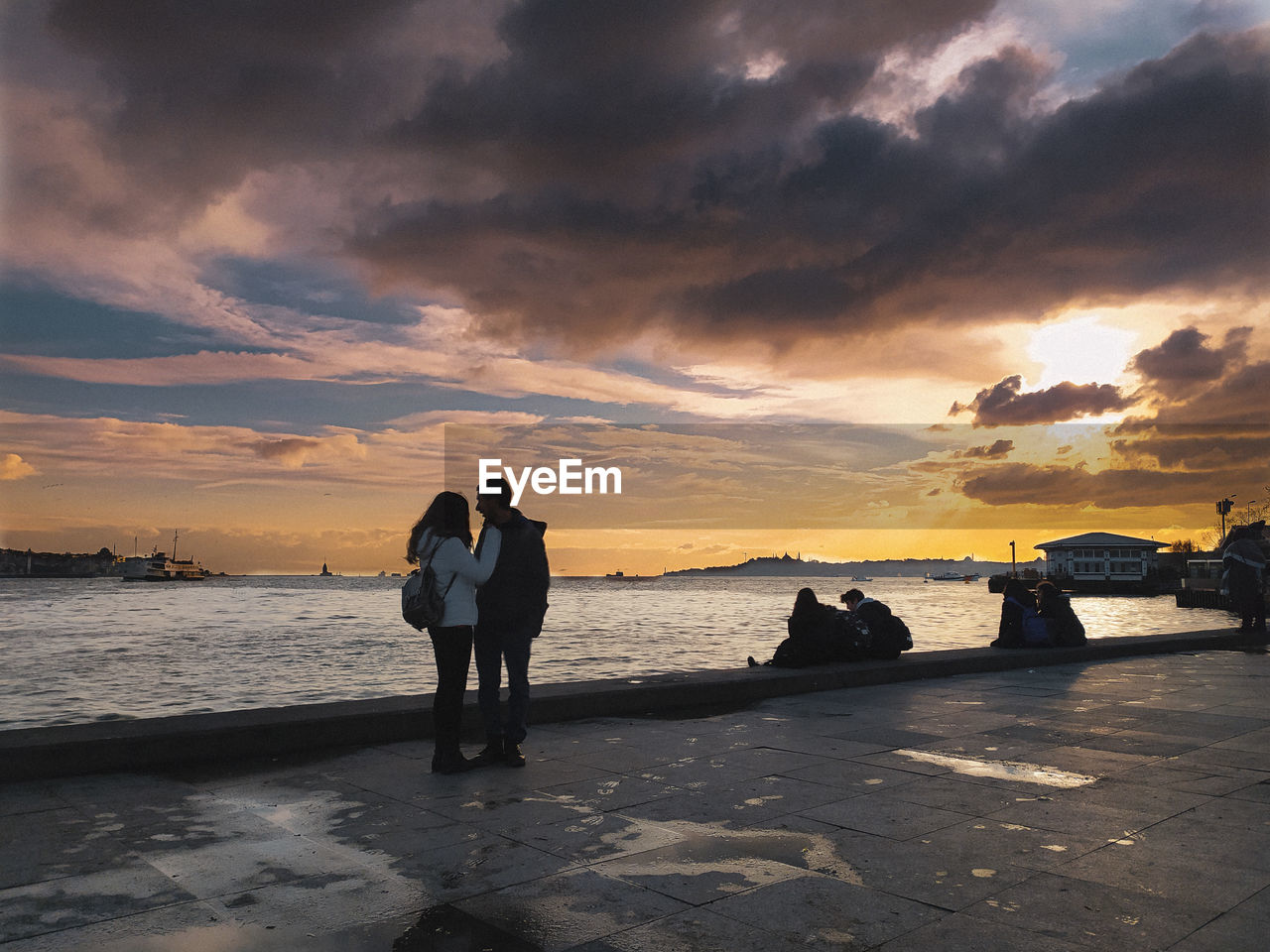 PEOPLE ON BEACH DURING SUNSET