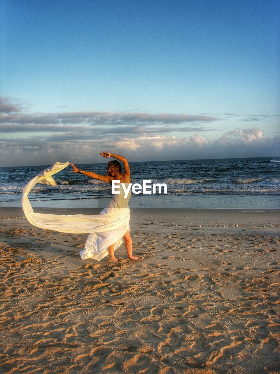 WOMAN WITH UMBRELLA ON BEACH