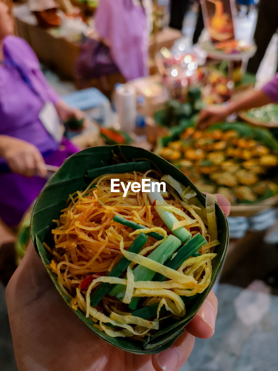 Close-up of hand holding thai noodle 