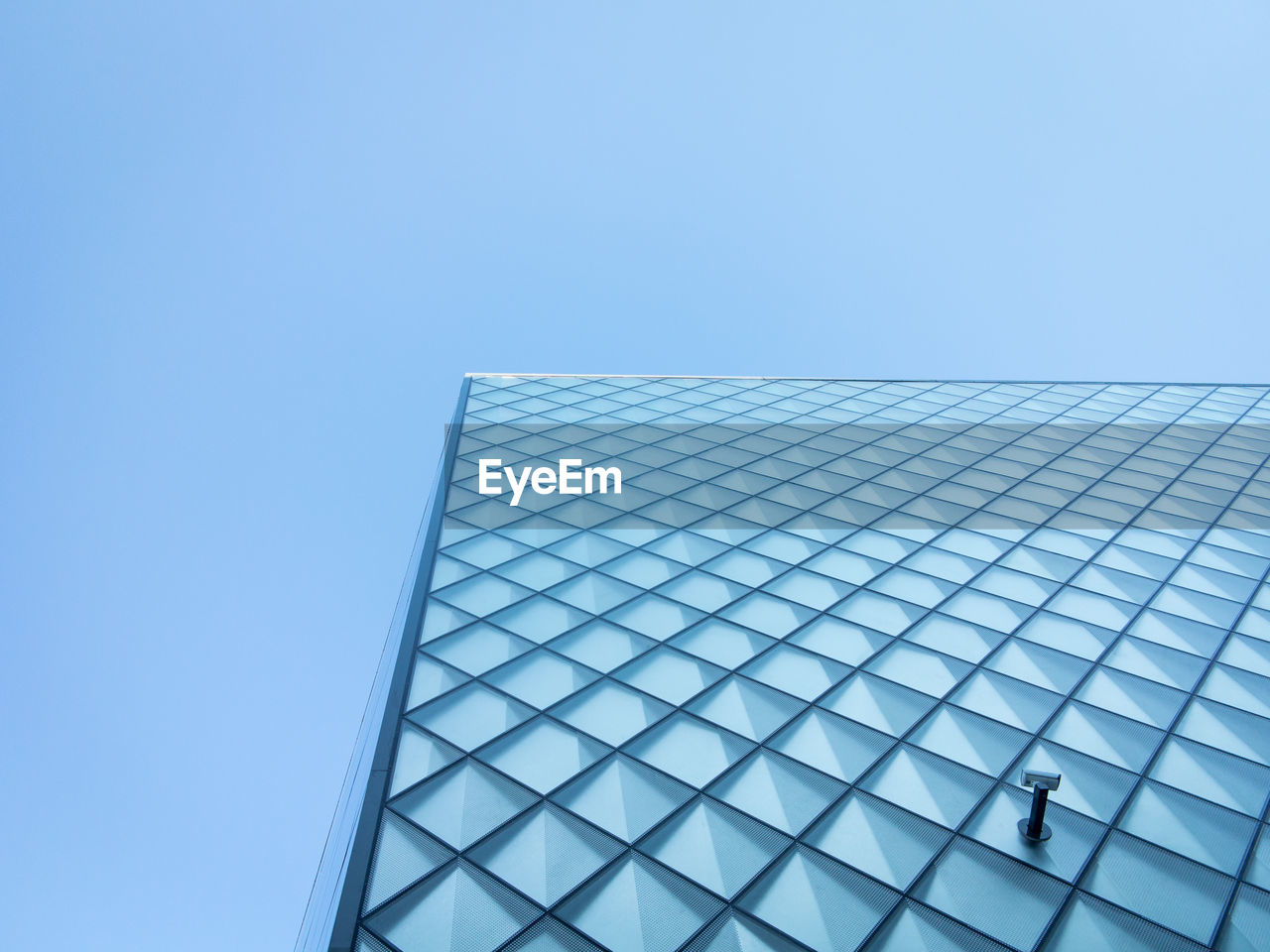 Low angle view of modern building against clear blue sky