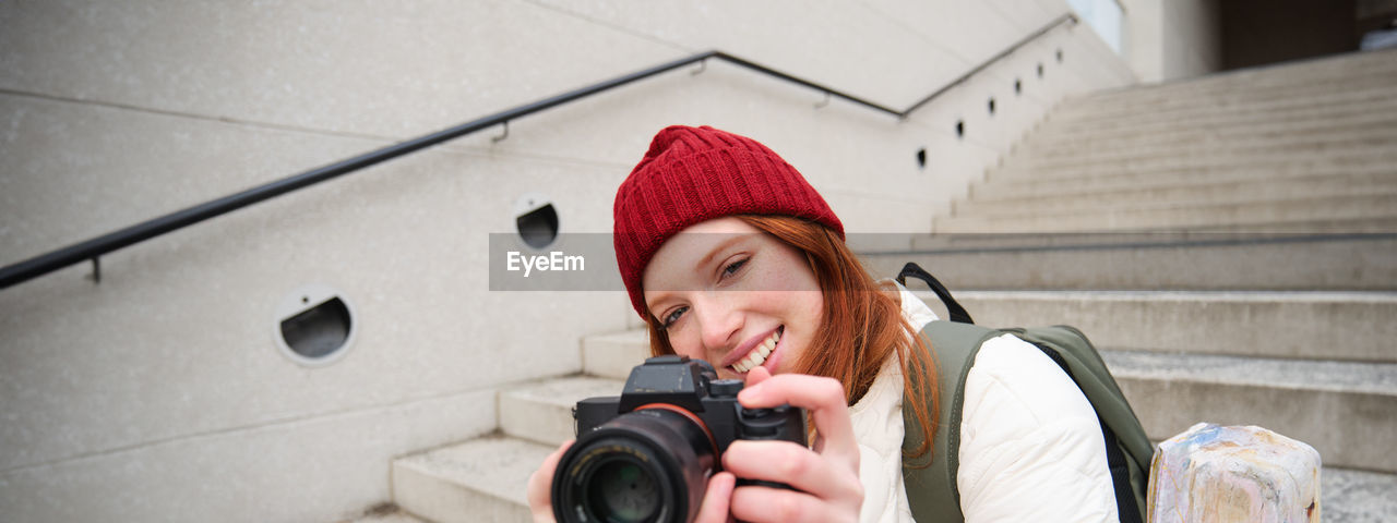 portrait of young woman photographing through camera