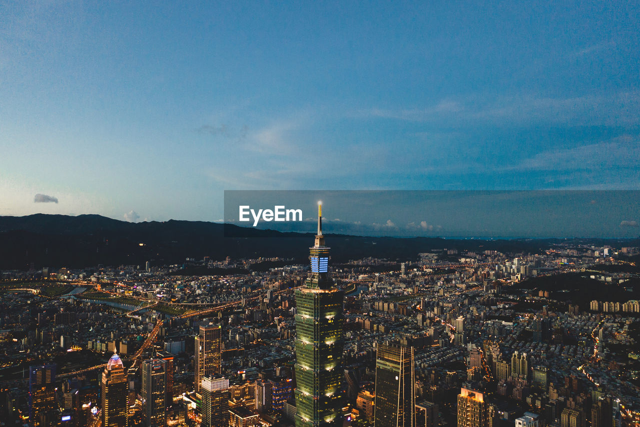 High angle view of city lit up at dusk