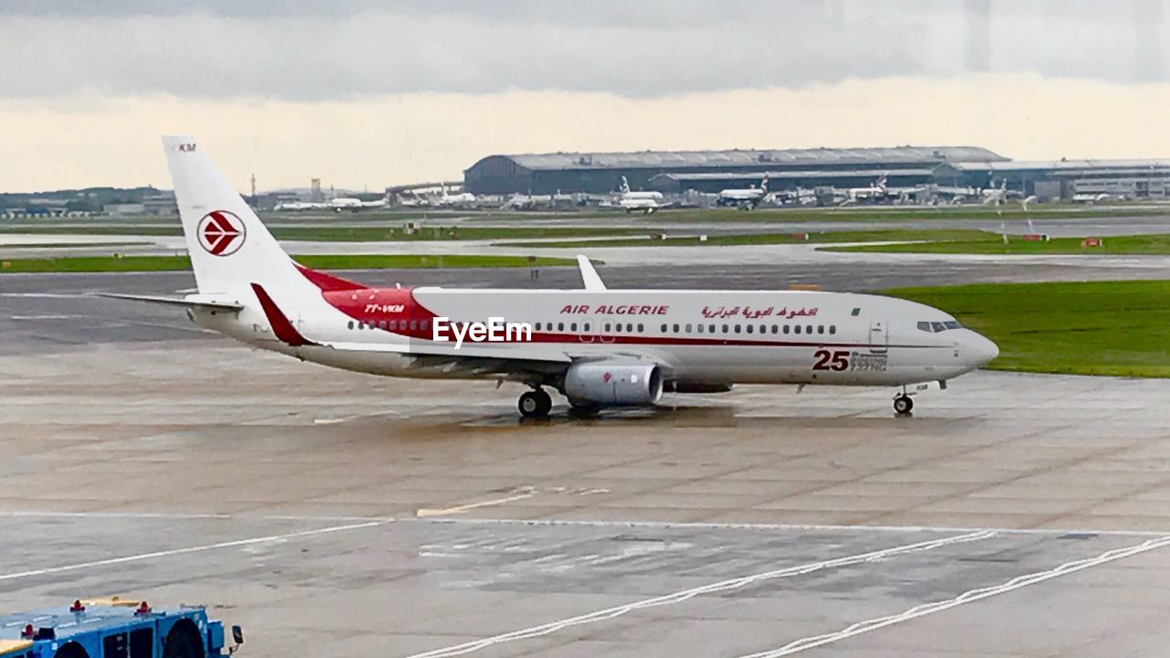 AIRPLANE AT AIRPORT RUNWAY