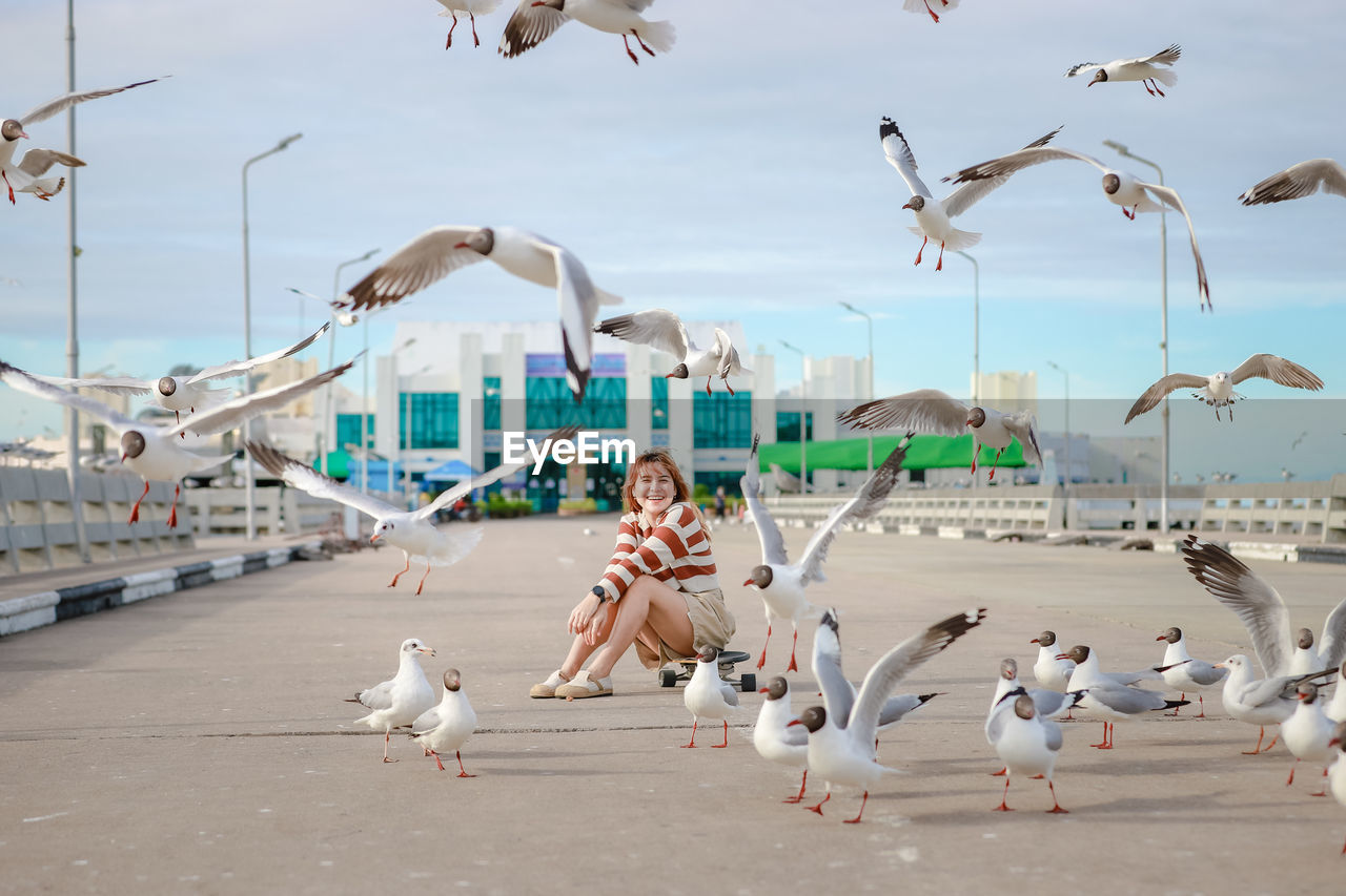 Asian woman striped shirt with seagull.