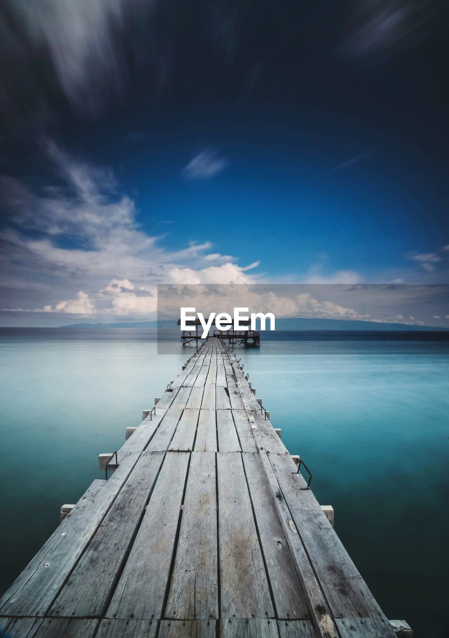 Pier over sea against sky