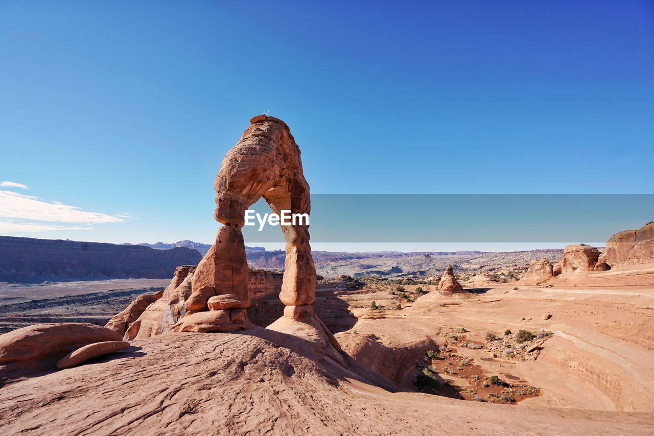 Rock formations in desert against blue sky