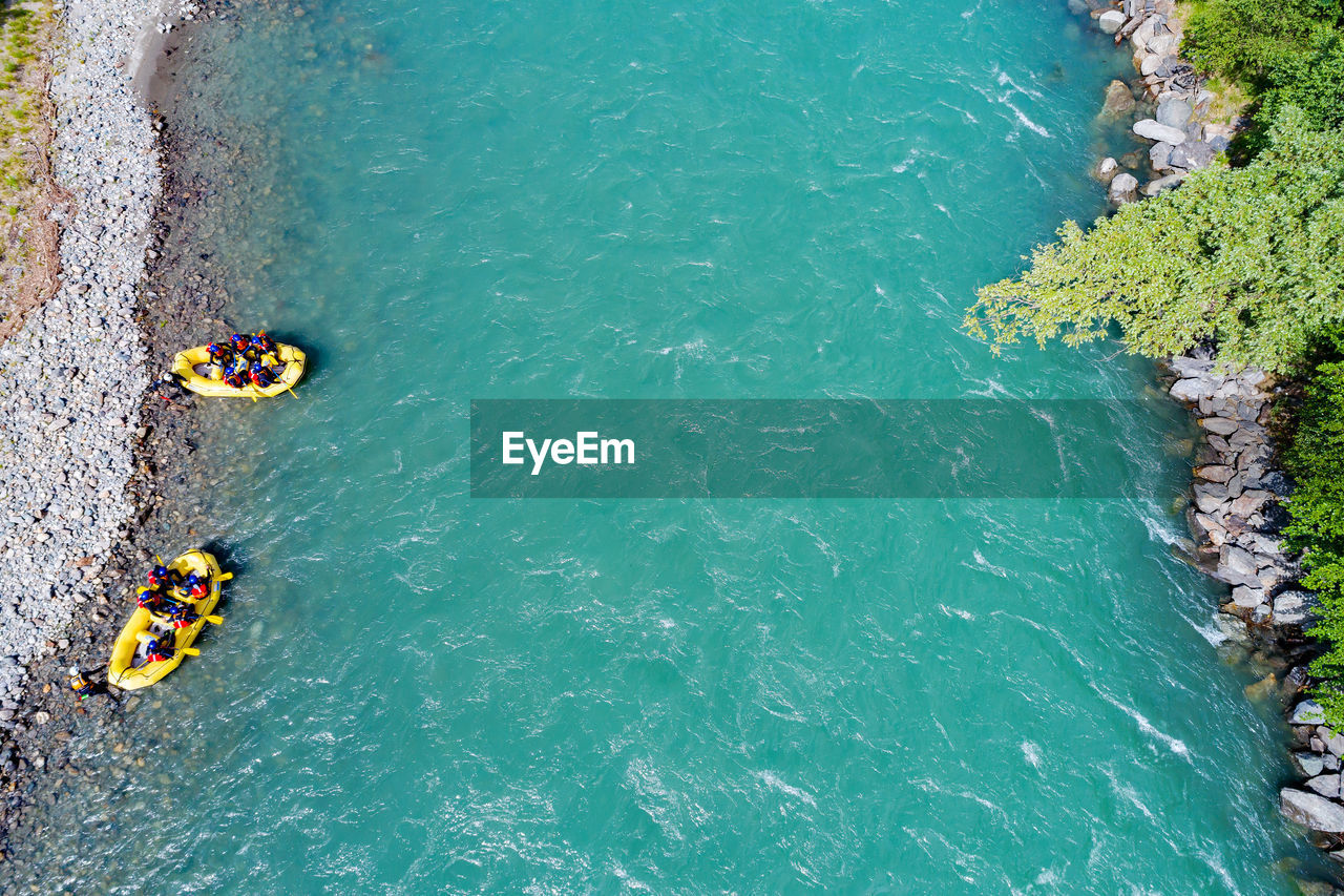 HIGH ANGLE VIEW OF PEOPLE ON SEA