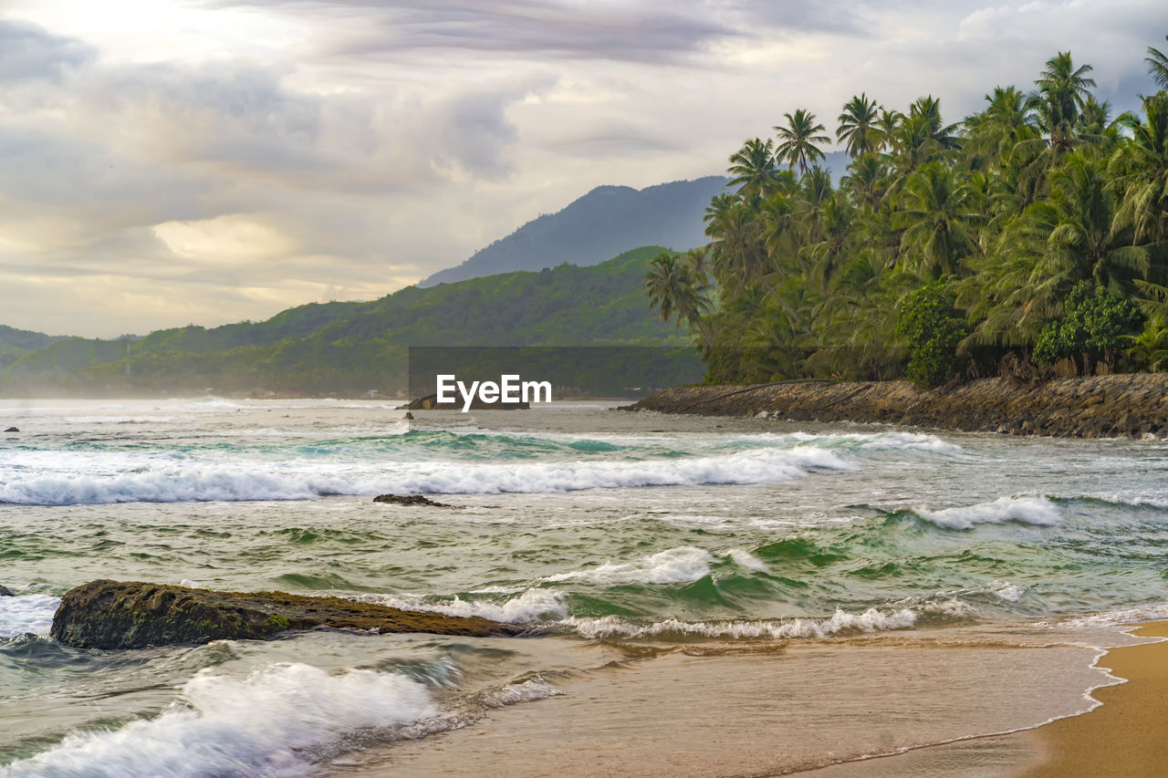 Sawang indah beach, tapaktuan, aceh. serene coastal paradise with swaying palm trees, pristine sands