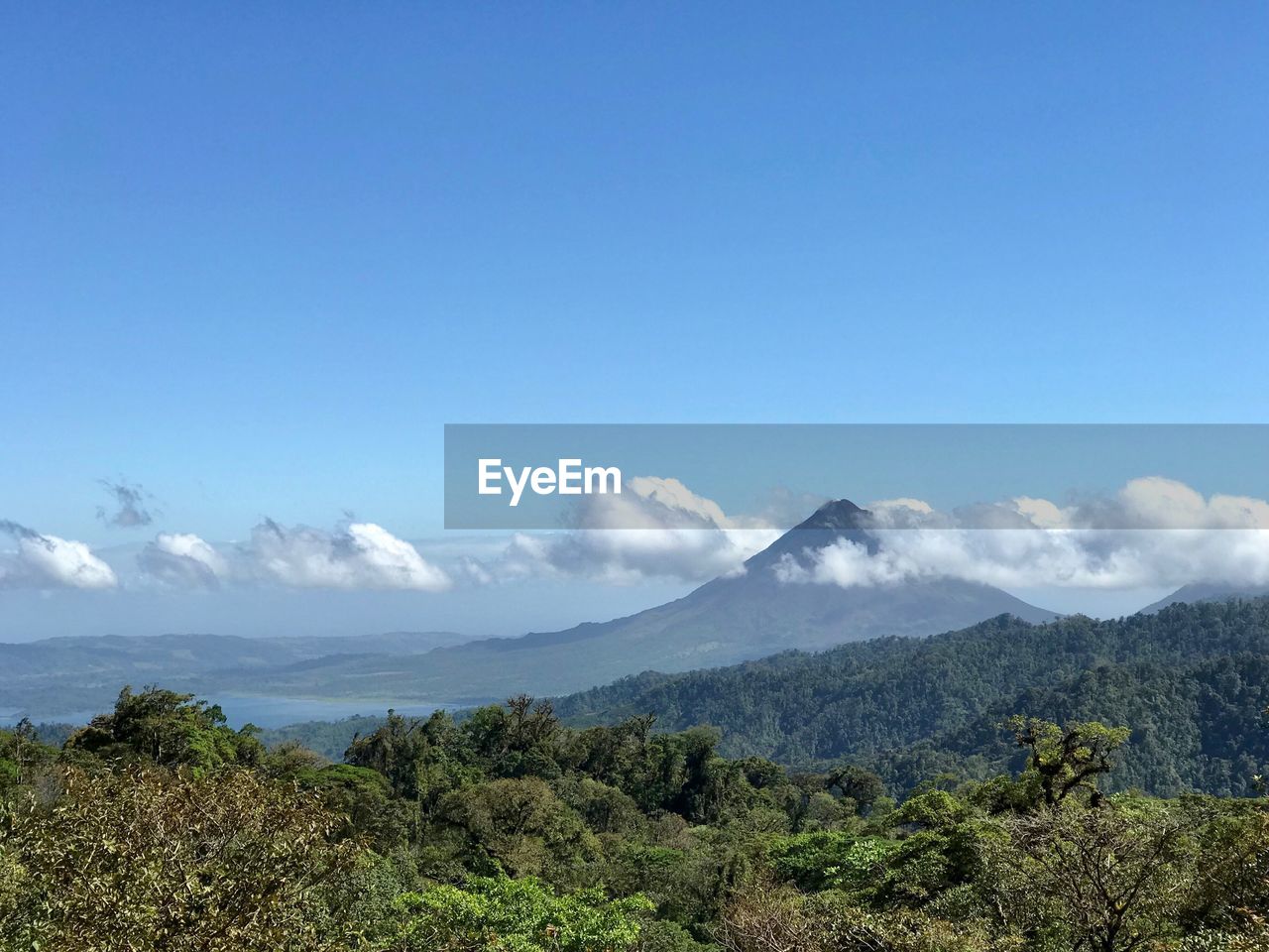 Scenic view of mountains against blue sky