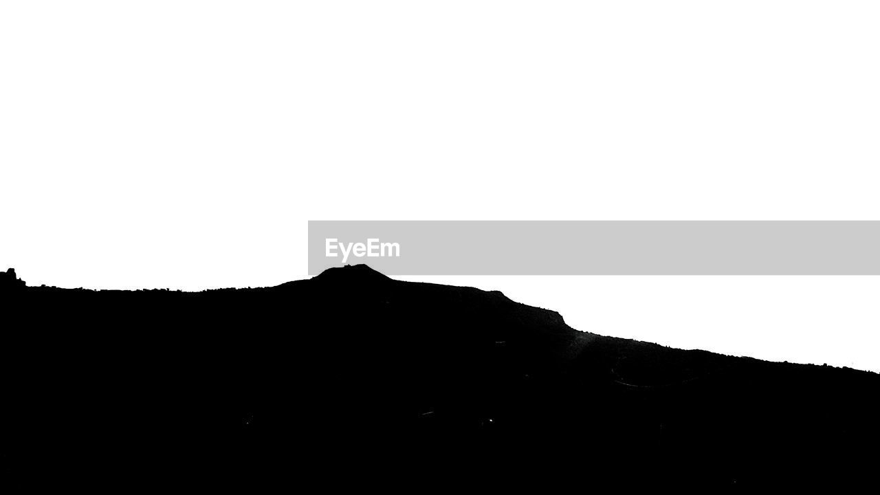 SILHOUETTE OF MOUNTAIN AGAINST CLEAR SKY
